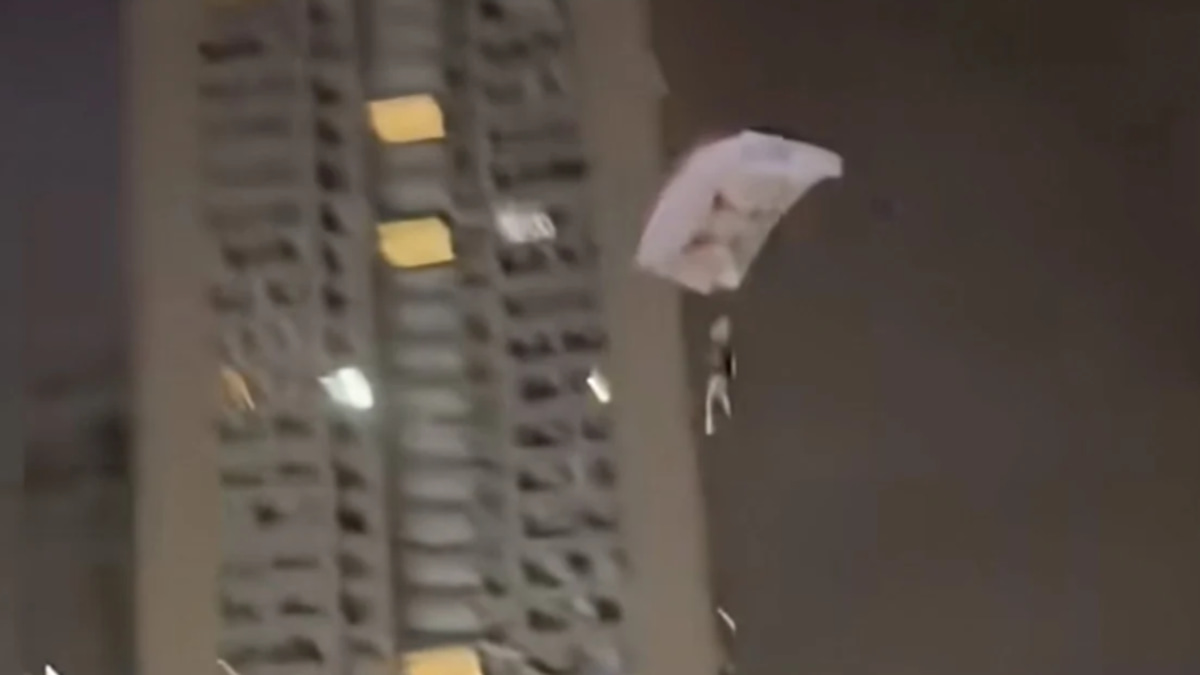 Chinese man detained after illegal rooftop skydive stunt for social media attention
