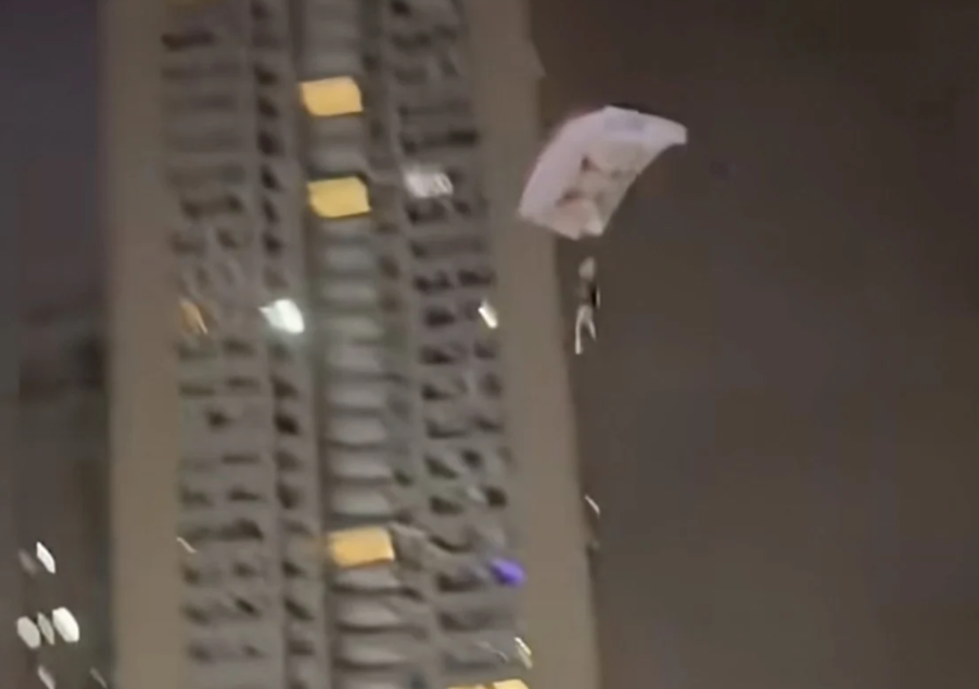 Chinese man detained after illegal rooftop skydive stunt for social media attention