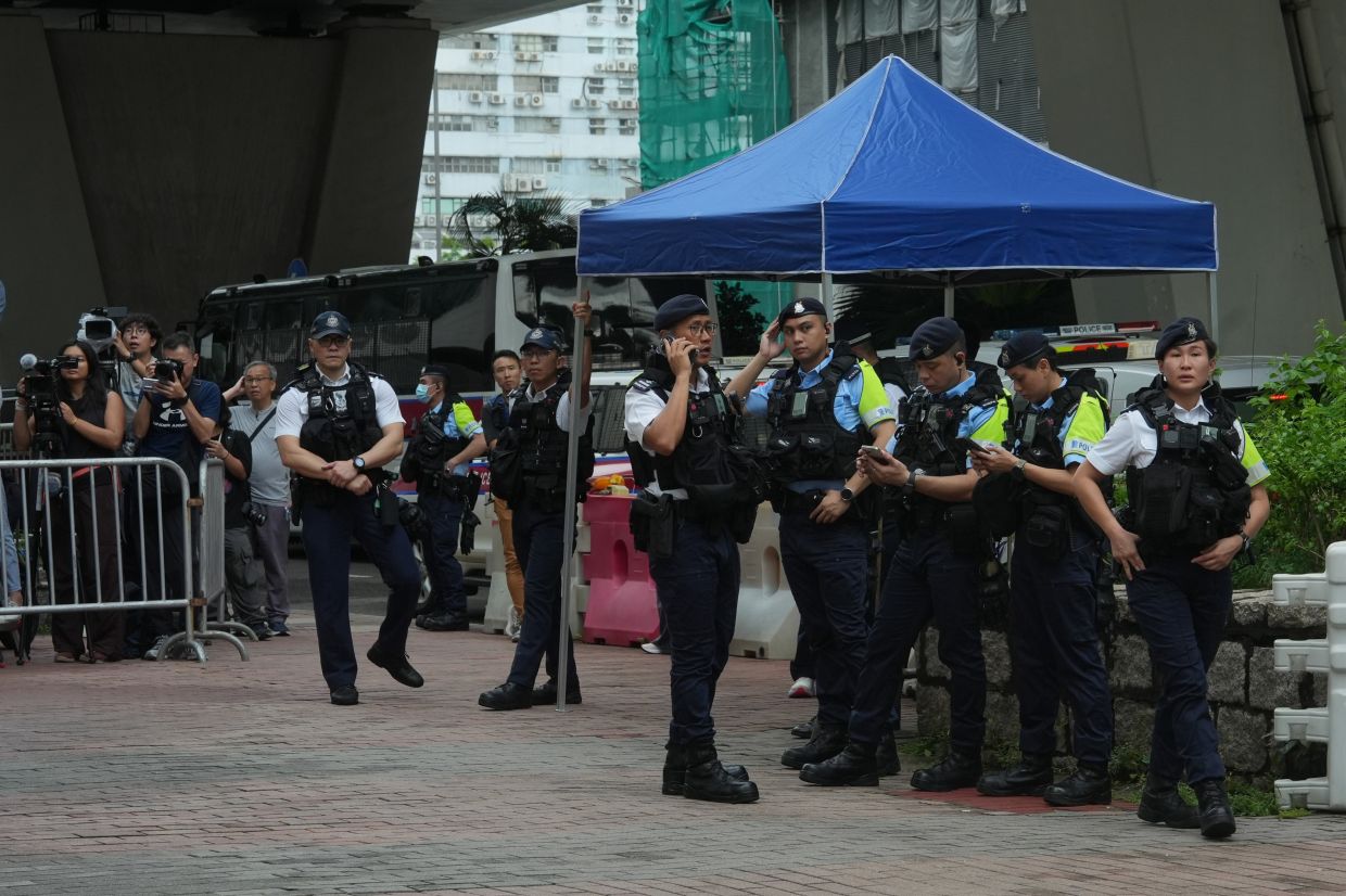 Hong Kong arrests woman over T-shirt amid sedition verdict against democracy activists